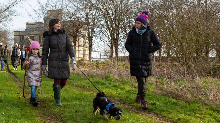 Walkers with a volunteer in the Lodge Park landscape